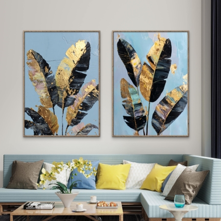 זוג תמונות קנבס בעיצוב יוקרתי של עלים שחורים עם נגיעות זהב על רקע תכלת – מתוך קולקציית תכשיט לבית.