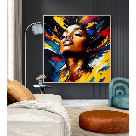 תמונת קנבס אבסטרקטית עם דיוקן נשי מלא הבעה, מוקף בהתפרצות צבעים מרהיבה בגווני אדום, כחול וצהוב, אמנות מודרנית דינמית ומלאת חיים.