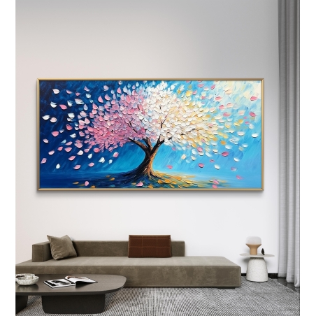 תמונת קנבס לרוחב של עץ מלא עלים צבעוניים בגווני ורוד, לבן וזהב המתפזרים על רקע שמיים כחולים, המשרה אווירה חיה, רכה ומלאת תקווה.