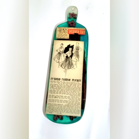 קרש הגשה מאפוקסי בצד אחד קטעי עיתונות מדבר השבוע משנות החמישים