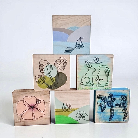 תמונה מחוטי ברזל על קוביה מעץ בעבודת יד