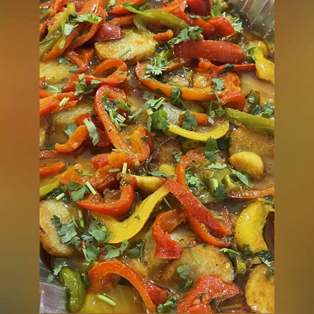 Tilapia fillet in yellow sauce with fried potatoes