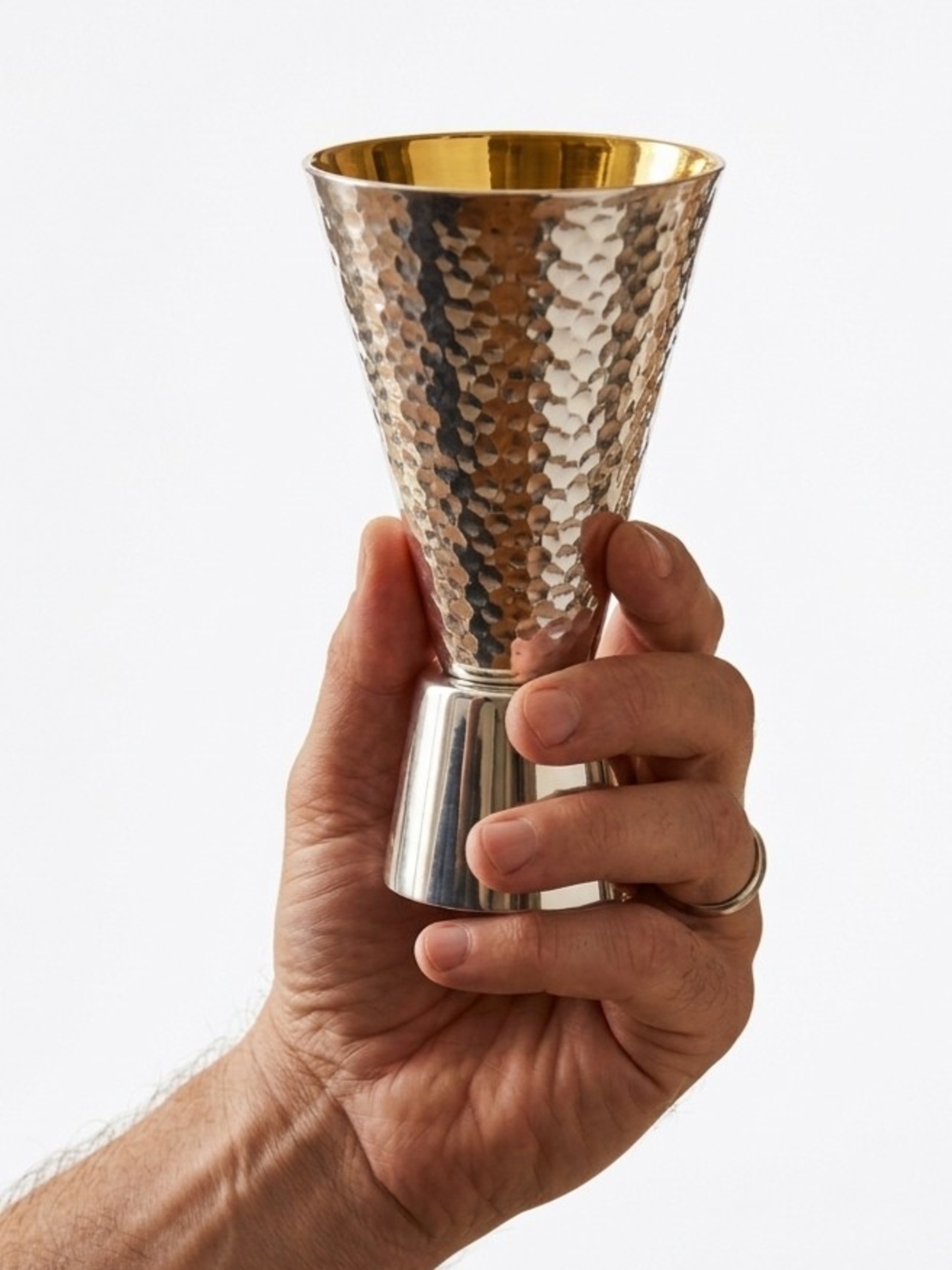 Hand Holding a Pure Silver Kiddush Cup – 
