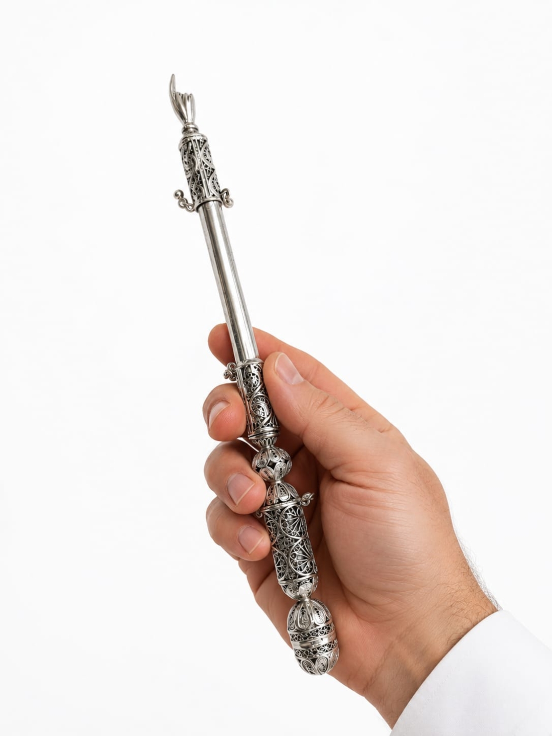 Hand holding a Torah scroll pointer, traditional filigree work made of 925 sterling silver