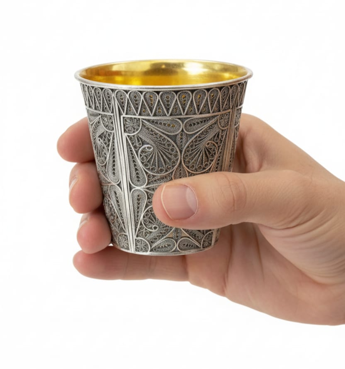 A hand holding a pure silver Kiddush cup, 