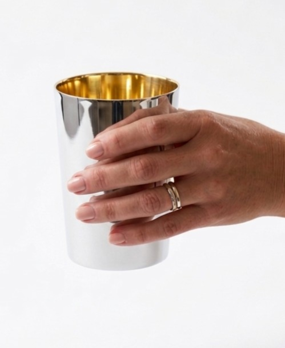 Hand holding a large, pure silver cylindrical Kiddush cup | Smooth or hand-hammered finish