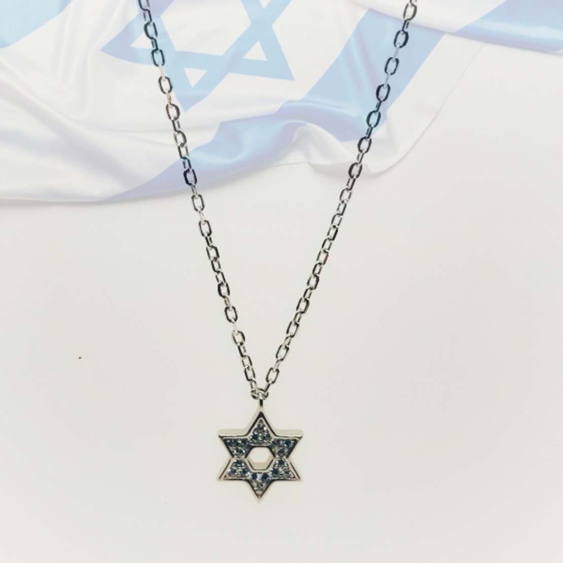 A small Star of David with zircons including a chain