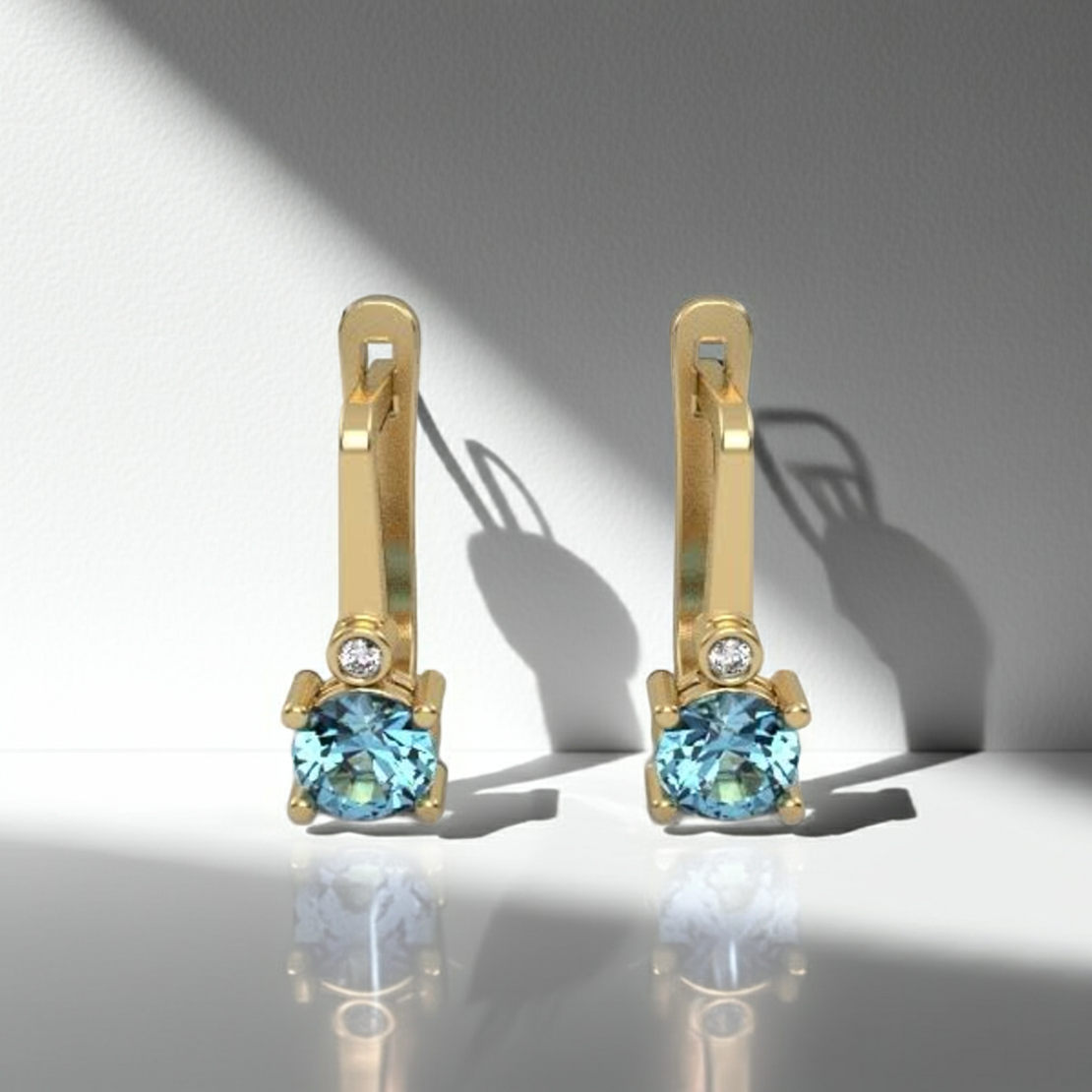 Earrings made of 14k gold set with Blue Topaz Suisse stones and diamonds model EAG36