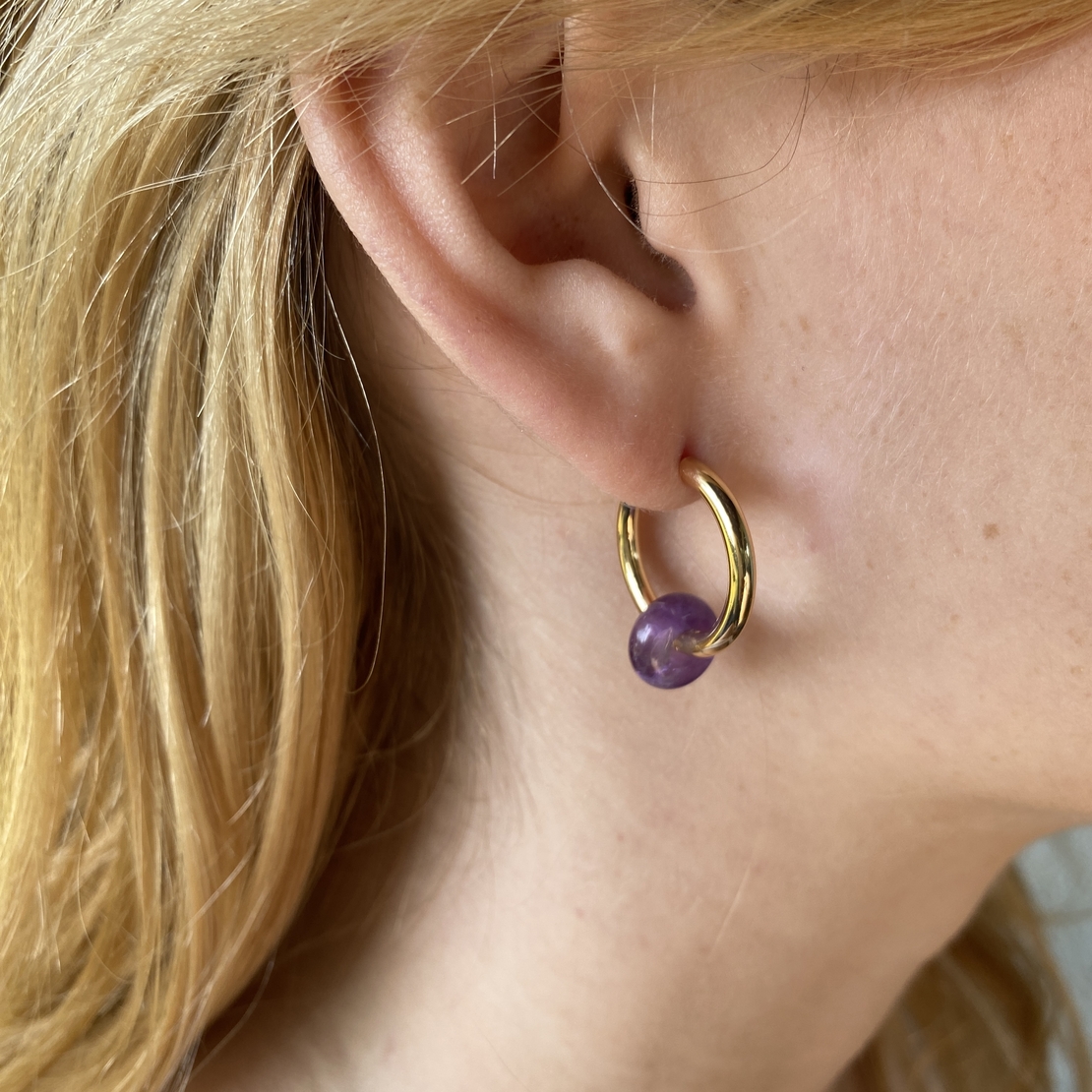 Gold plated hoop earrings with a stone bead - amethyst