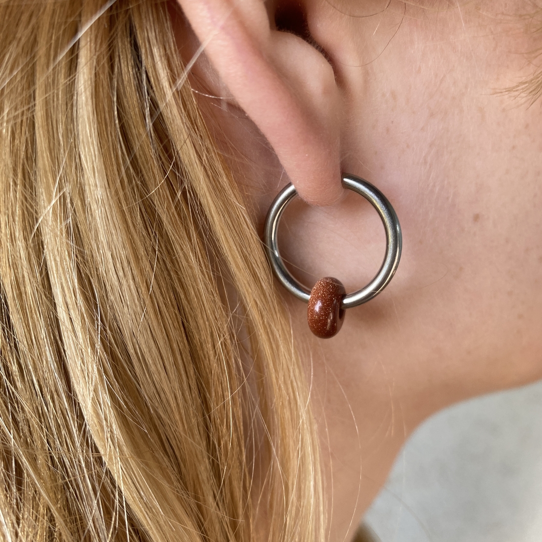 Silver plated hoop earrings with a stone bead - sparkling red