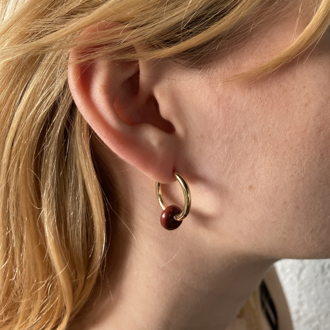 Gold plated hoop earrings with a stone bead - wine red