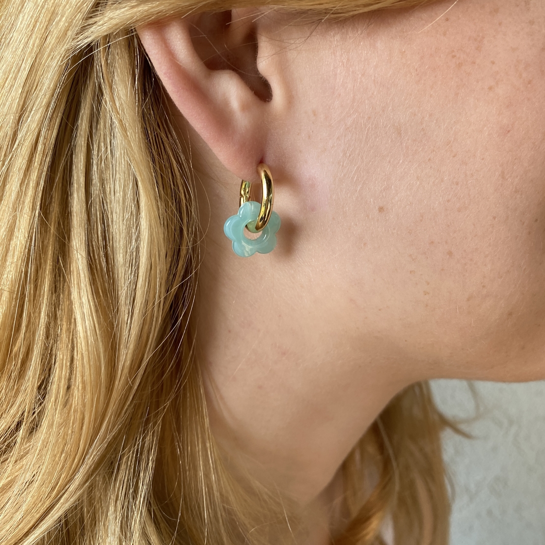 Gold plated hoop earrings with a stone bead - light blue flower