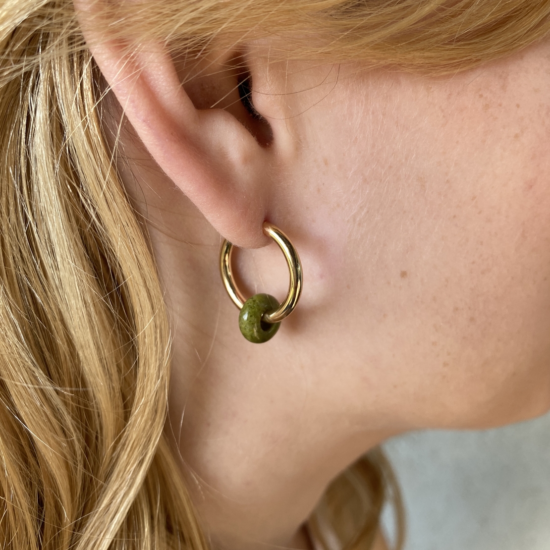 Gold plated hoop earrings with a stone bead - india green