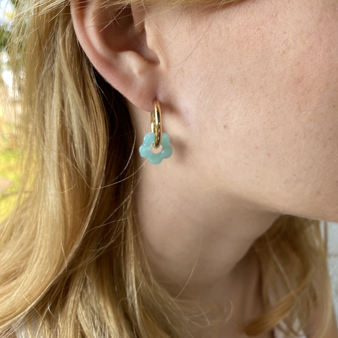 Gold plated hoop earrings with a stone bead - light blue flower