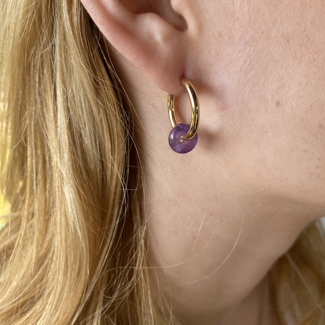 Gold plated hoop earrings with a stone bead - amethyst