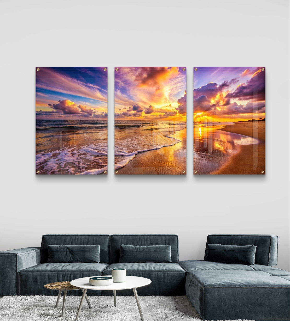 שלישיית תמונות זכוכית של חוף ים בשקיעה עם שמיים צבעוניים והשתקפות על החול, עיצוב יוקרתי לסלון
