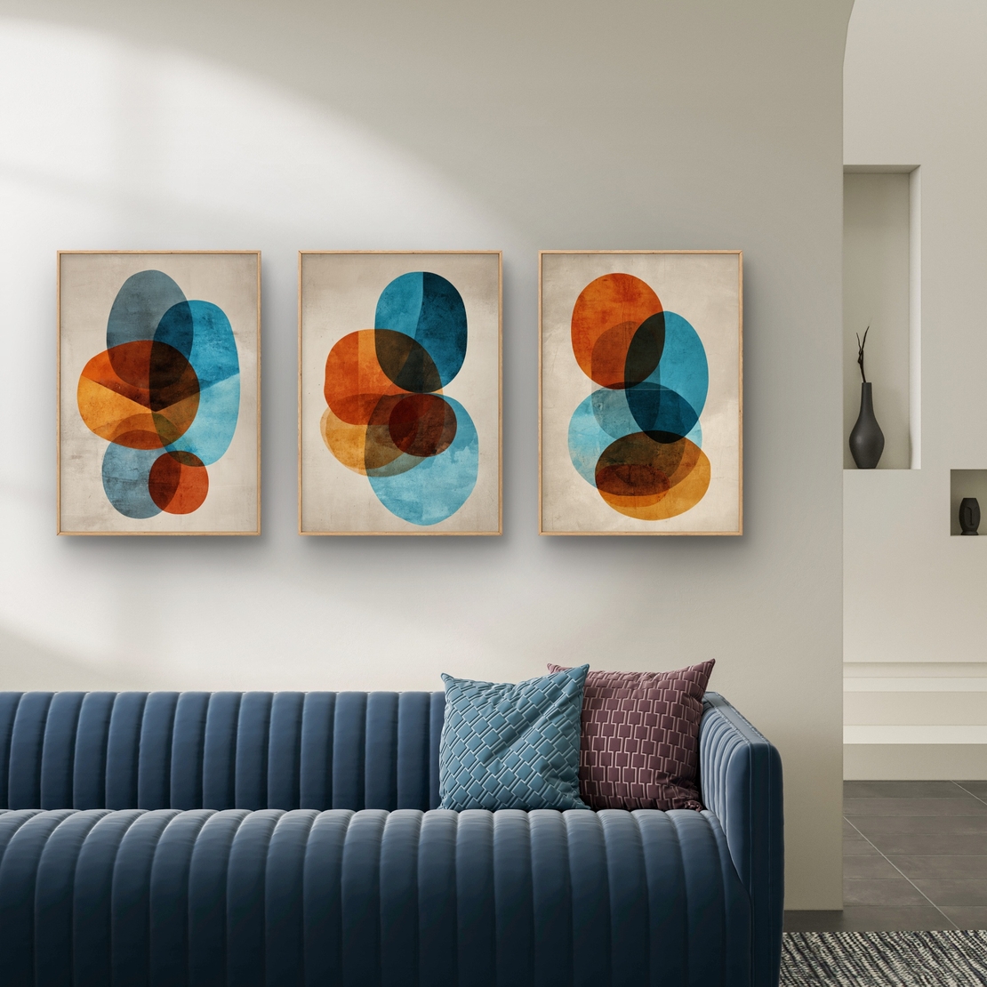 סט של שלוש תמונות קנבס אבסטרקטיות עם צורות עגולות בגווני כחול, כתום וחום על רקע בהיר, בעיצוב מודרני ואלגנטי לסלון.